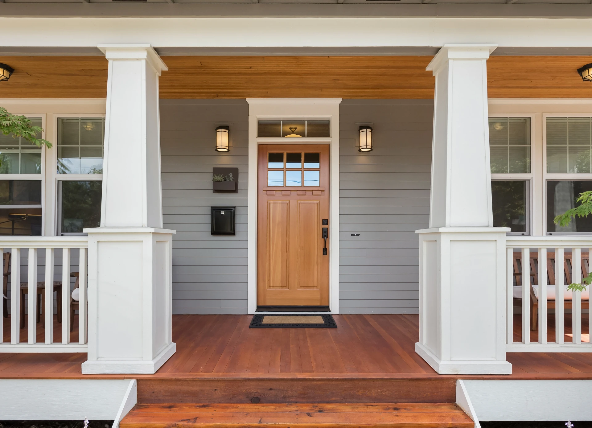 Craftsman-style porch with gray siding and white architectural trim