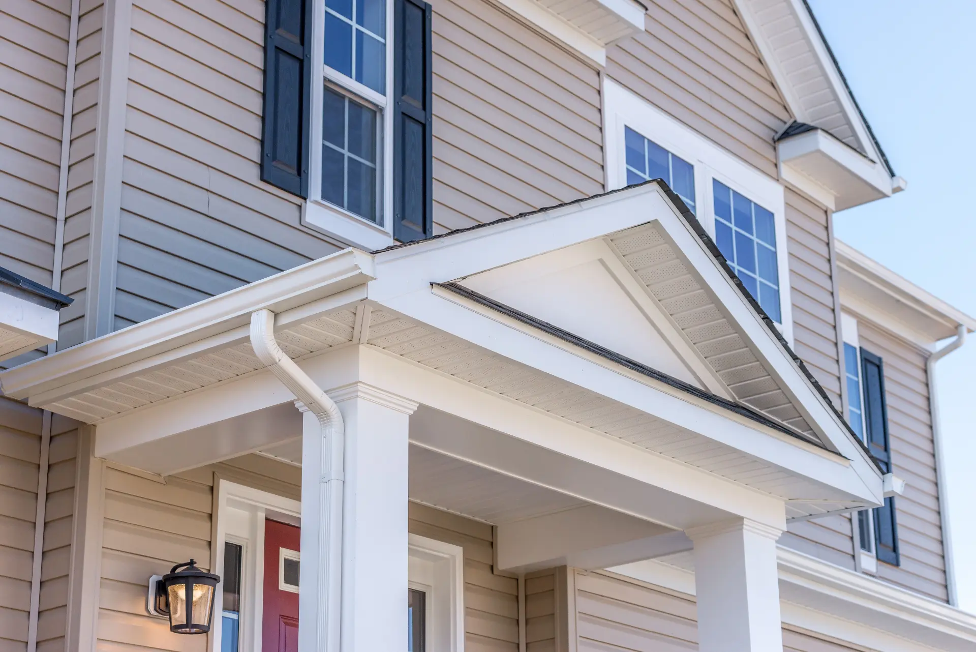 Siding, windows, trim, and gutter details on a finished exterior